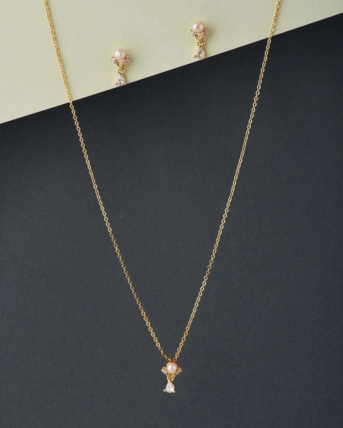 A cute pendant matched with golden polish chain with matching earrings.