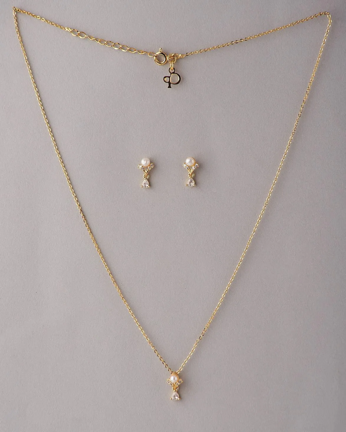 A cute pendant matched with golden polish chain with matching earrings.